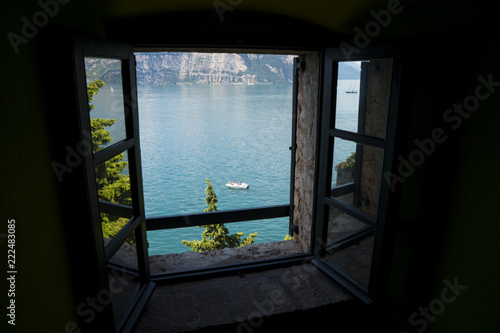 Window on Lake Garda (Italy), a holiday area appreciated by many European tourists. Lake panorama seen through a window.