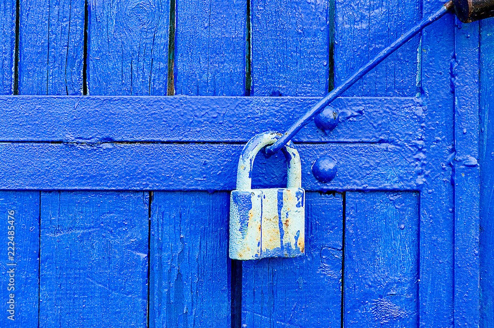 door lock for key closing, keyhole, hasp bolt. Collection of old vintage retro locks on the textured colored door. Close-up