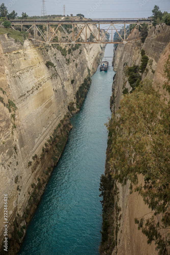 Corinth, Greece: A ship travels through the narrow passage of the Corinth Canal.
