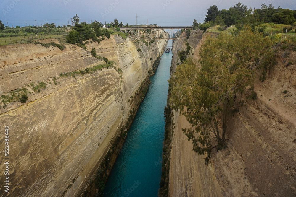 Corinth, Greece: A ship travels through the narrow passage of the Corinth Canal.