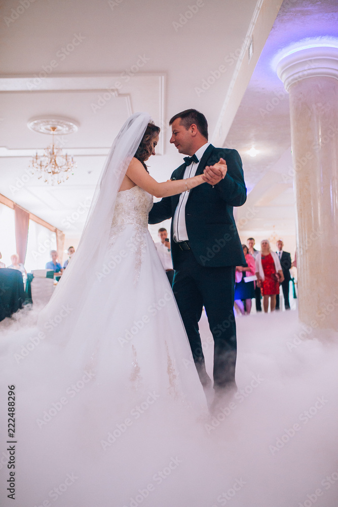 First wedding dance of newlywed. Bride and groom dancing around a lot of confetti.