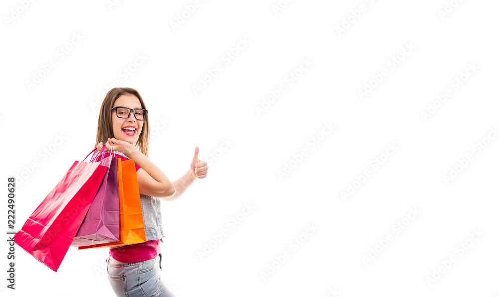 Young woman with shopping bags showing thumb up Young woman with shopping bags showing thumb up