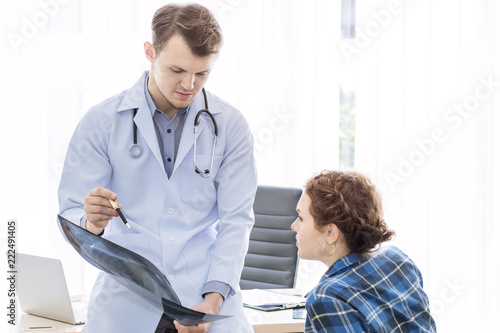 Medical professionals caucasian man reassuring and talking with young woman stress patient.Close up and copy space.
