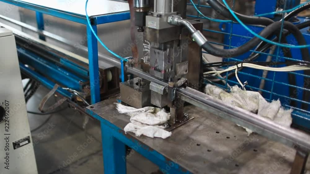 at the plant, the press makes holes in new steel profiles. Creation of metal profiles. Automatic press. at the plant, the press makes holes in new steel profiles. Creation of metal profiles. Automatic press.