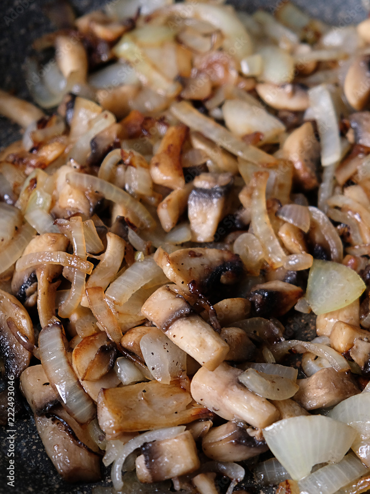 fried mushrooms with onions in a frying pan fried mushrooms with onions in a frying pan