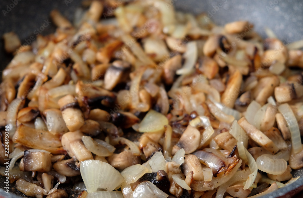 fried mushrooms with onions in a frying pan fried mushrooms with onions in a frying pan
