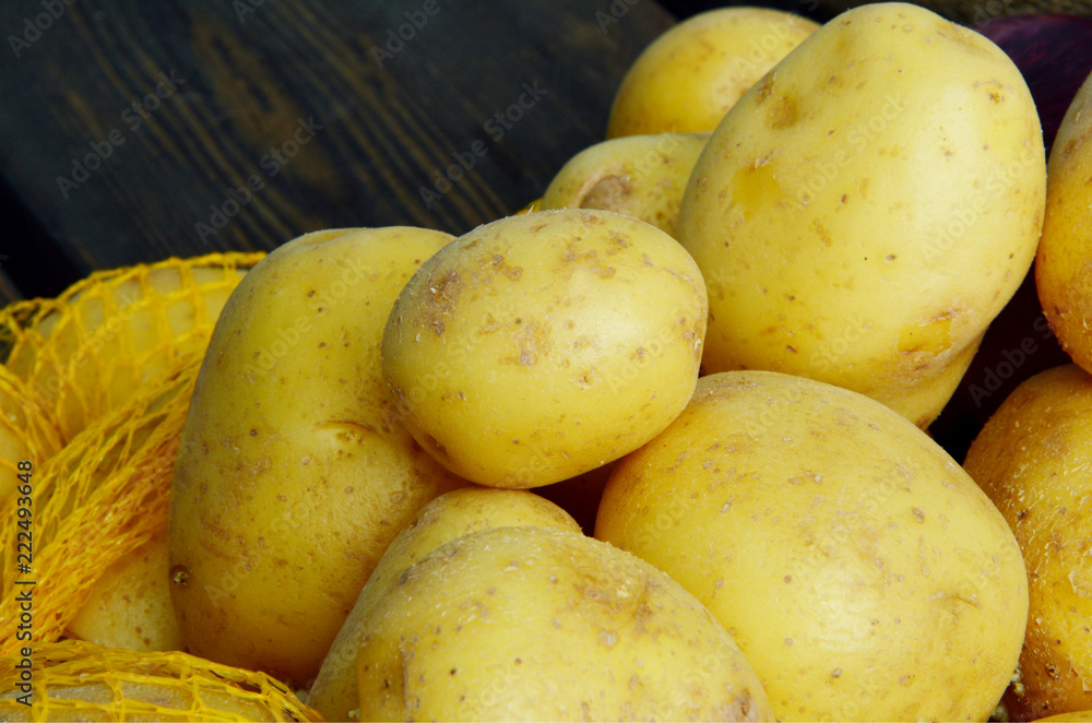 Fresh Many Potatoes and Potato Net Bag Packing with full frame. Fresh Many Potatoes and Potato Net Bag Packing with full frame.