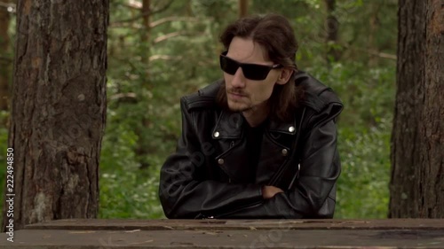 the guy in the leather jacket and glasses