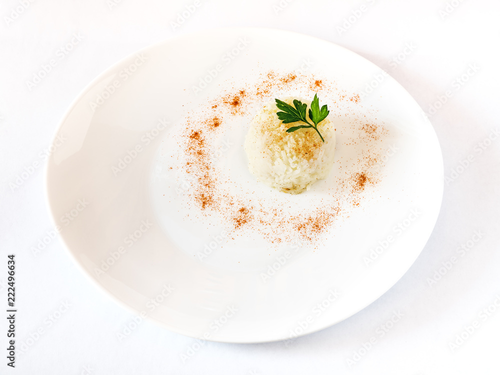 Rise served on a white plate garnish with paprika and parsley leaf. White background, space for text Rise served on a white plate garnish with paprika and parsley leaf. White background, space for text