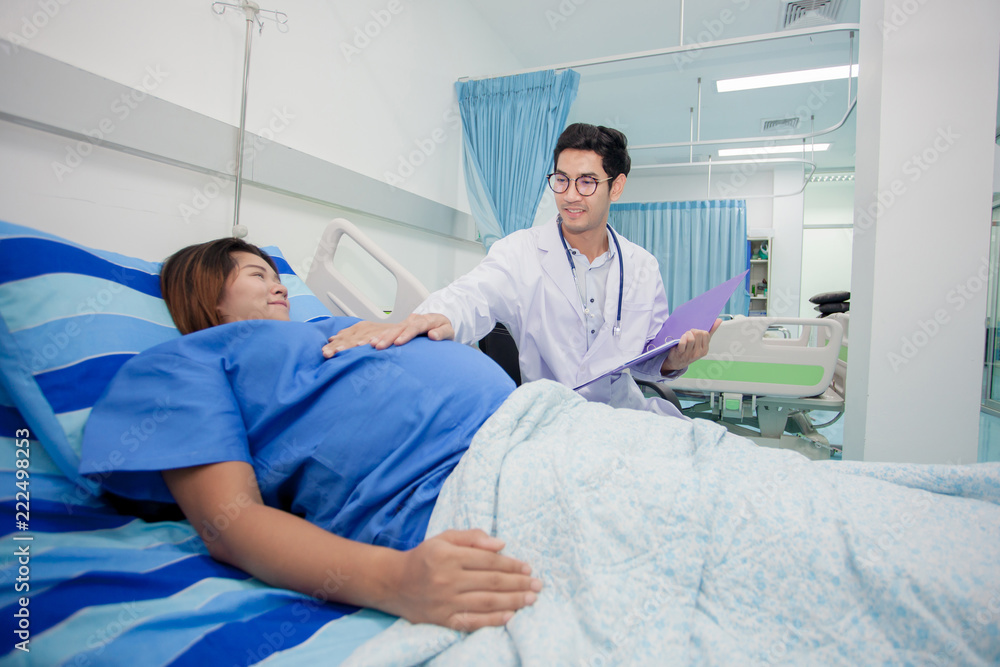 Young preganant woman expecting a baby doctor visit. Cropped image of doctor using stethoscope examining pregnant woman Young preganant woman expecting a baby doctor visit. Cropped image of doctor using stethoscope examining pregnant woman