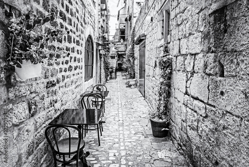 Narrow street in historic Trogir, colorless