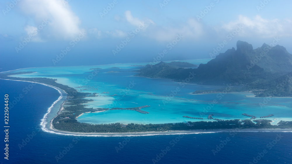 Flying Over Bora Bora's Blue Lagoon In French Polynesia - obrazy, fototapety, plakaty 