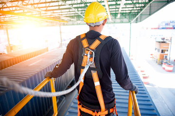 Construction worker use safety harness and safety line working on a new construction site project.