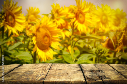 Fototapeta Naklejka Na Ścianę i Meble -  beautiful sunflowers and an old wooden table  