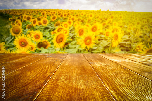 Fototapeta Naklejka Na Ścianę i Meble -  beautiful sunflowers and an old wooden table  