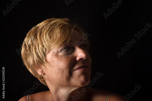 portrait of a middle aged woman on black