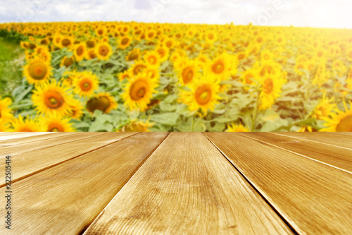 Fototapeta Naklejka Na Ścianę i Meble -  beautiful sunflowers and an old wooden table  