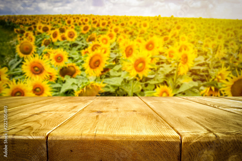 Fototapeta Naklejka Na Ścianę i Meble -  beautiful sunflowers and an old wooden table  