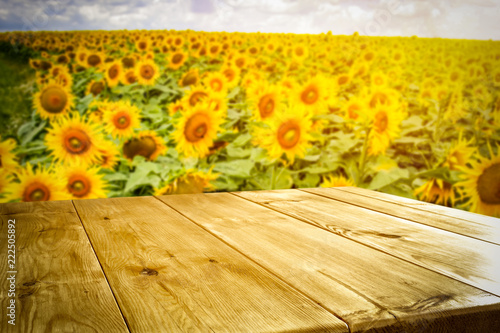 Fototapeta Naklejka Na Ścianę i Meble -  beautiful sunflowers and an old wooden table  