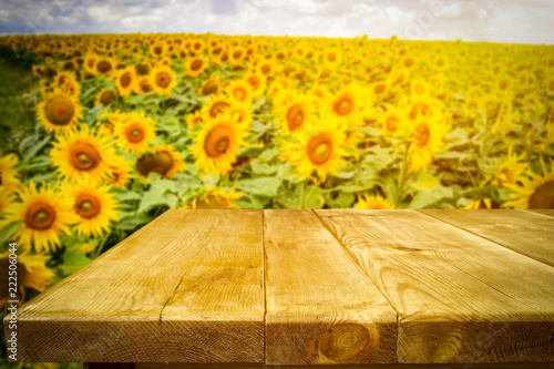 Fototapeta Naklejka Na Ścianę i Meble -  beautiful sunflowers and an old wooden table  