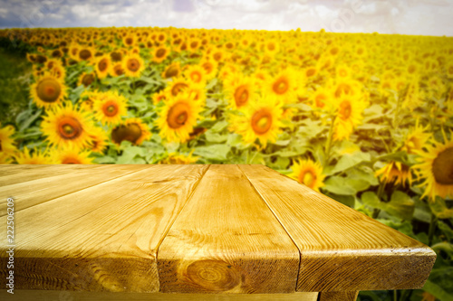 Fototapeta Naklejka Na Ścianę i Meble -  beautiful sunflowers and an old wooden table  