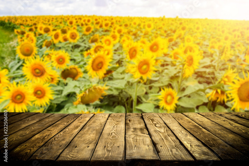 Fototapeta Naklejka Na Ścianę i Meble -  beautiful sunflowers and an old wooden table  