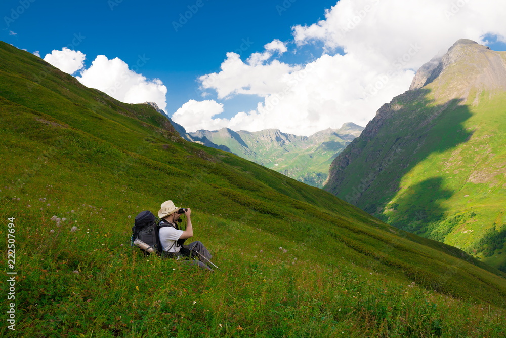 A man in mountain day summer. Green forest