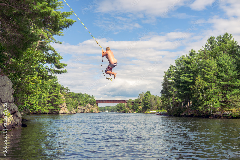 Rope swing over water Stock Photo