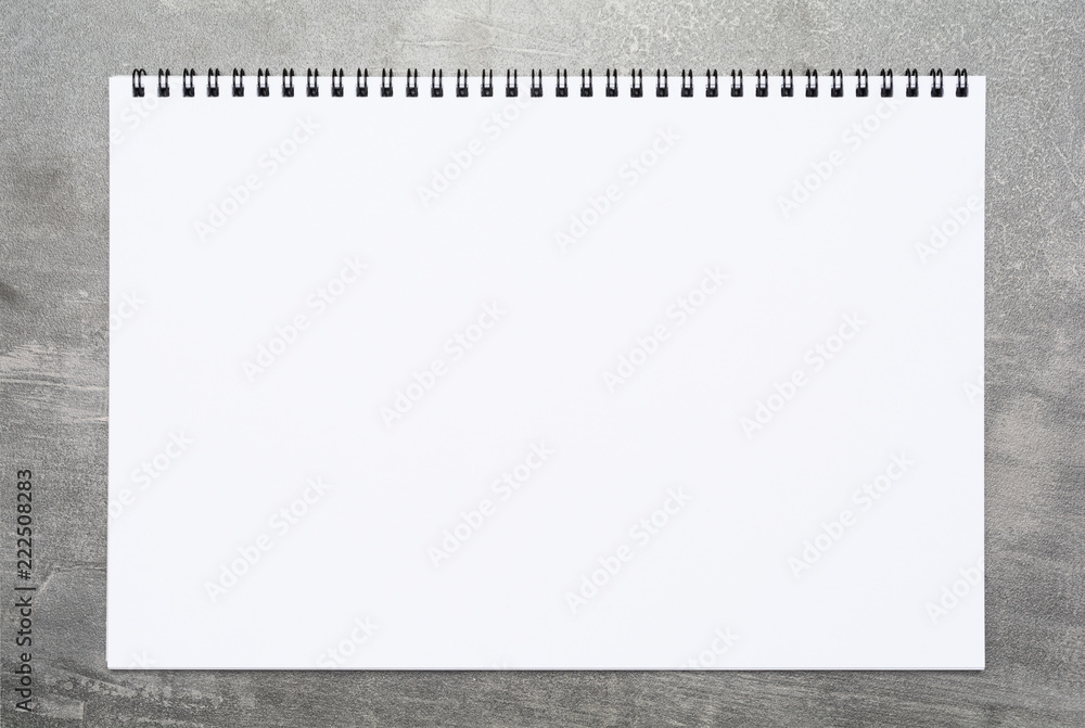 Blank page of a sketchbook on a gray surface Blank page of a sketchbook on a gray surface
