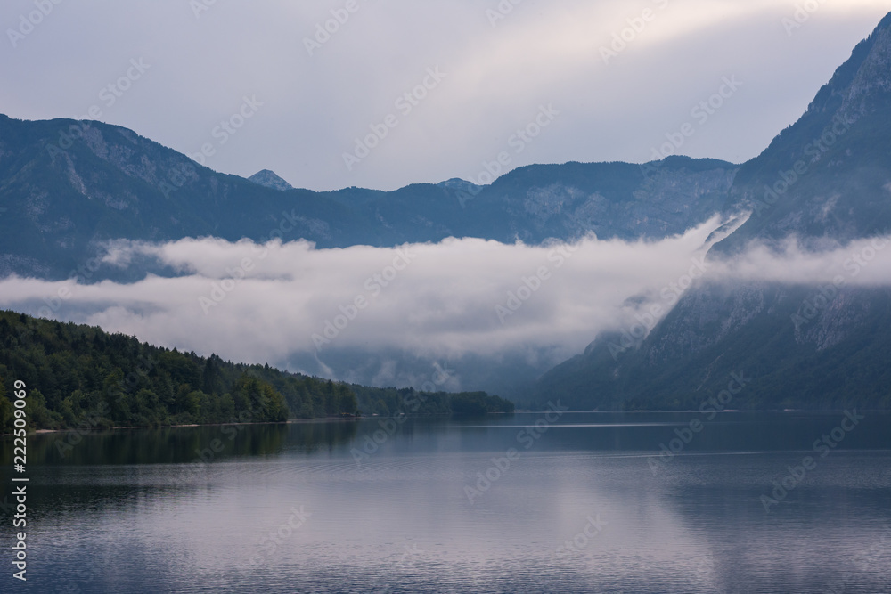 Bohinj lake, Slovenia. Big cloud above the lake. Summer evening in Julian alps