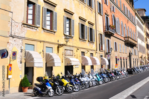 Editorial . Large Parking mopeds in the Ancient city of Florence Italy  The street of ancient buildings. 