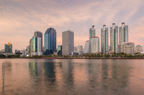 Scenic view of a lake at the Benjakiti (Benjakitti) Park and skyscrapers in Bangkok, Thailand, at sunset. © tuomaslehtinen