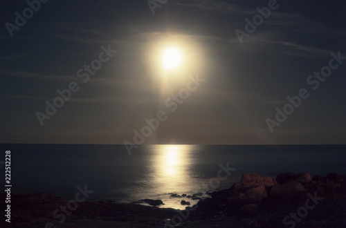 Looks like the sun but it's a long exposure of the moon over rocky cliffs and the sea.   © Grenar