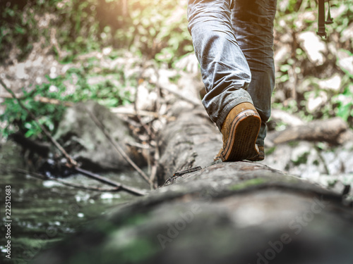 Close up Shoes of traveler walking in the forest. Lifestyle hiking concept.Travel hiking