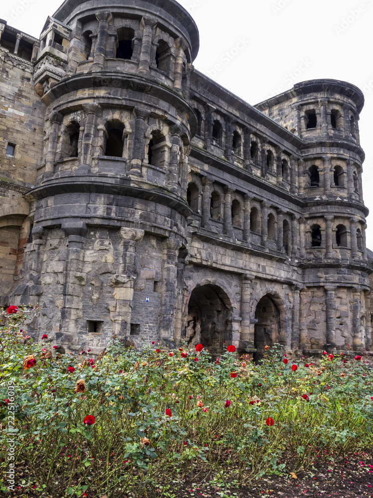Porta Nigra - a Roman city gate in Trier - the oldest city in Germany with a rose alley in front, view from the main street