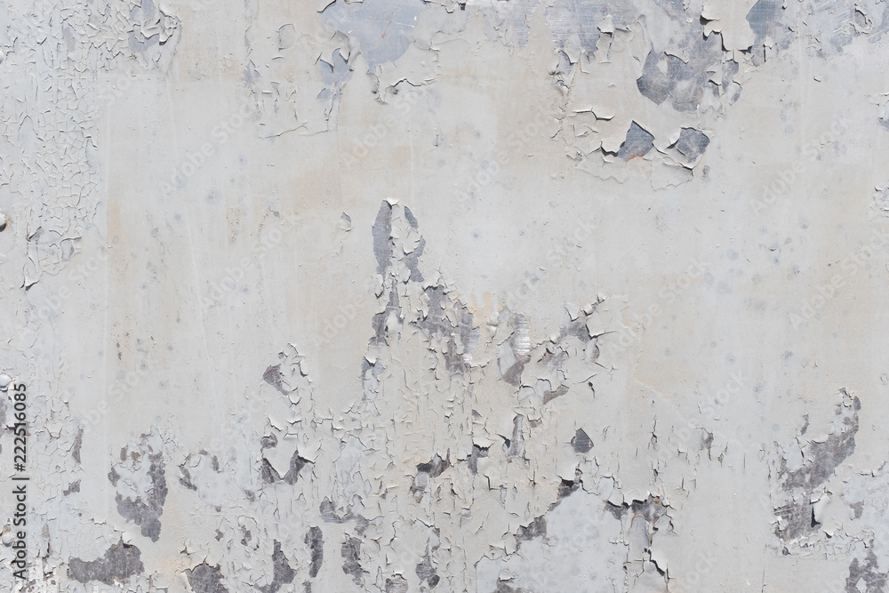 Grunge white metal wall with peeling paint, close-up background photo texture