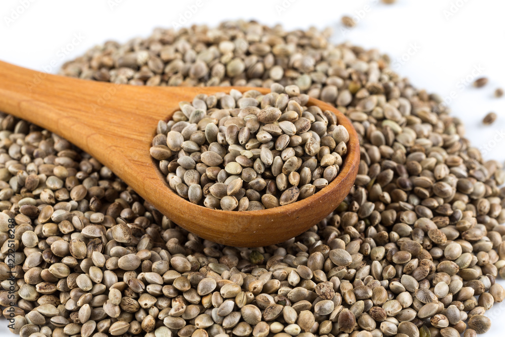 Cannabis Hemp seeds in spoon on white Cannabis Hemp seeds in spoon on white
