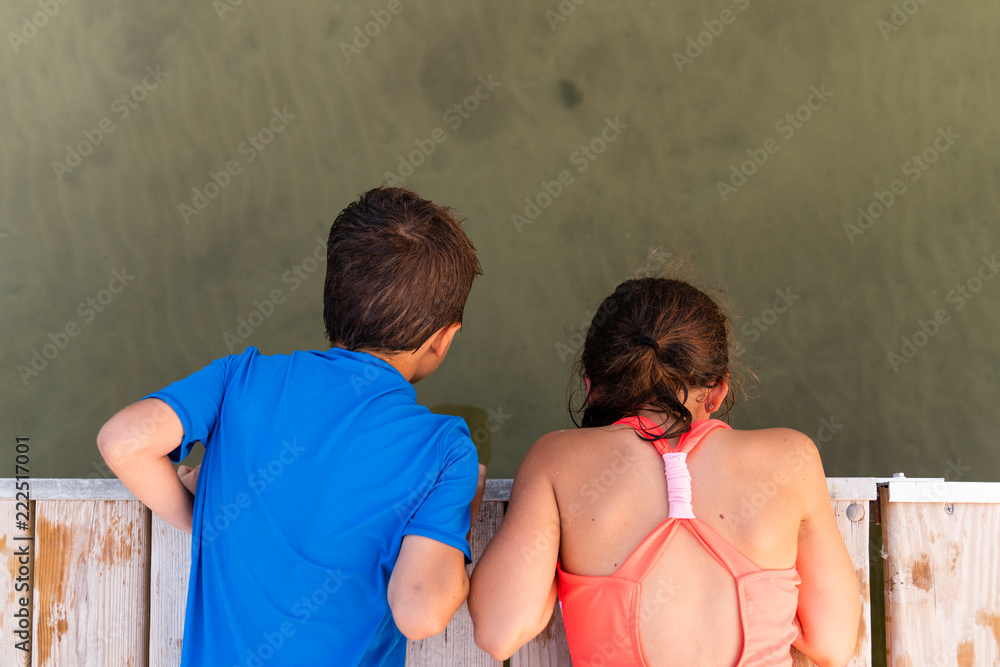 girl butch boyish bend over Boy and girl bending over pier and looking at lake Stock Photo | Adobe Stock