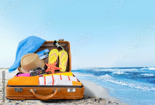 Retro suitcase with travel objects  on hotel background