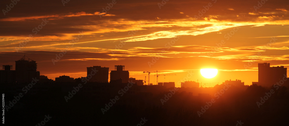 Panoramic view of cityscape with silhouette of city skyline against setting sun. Minsk, Belarus