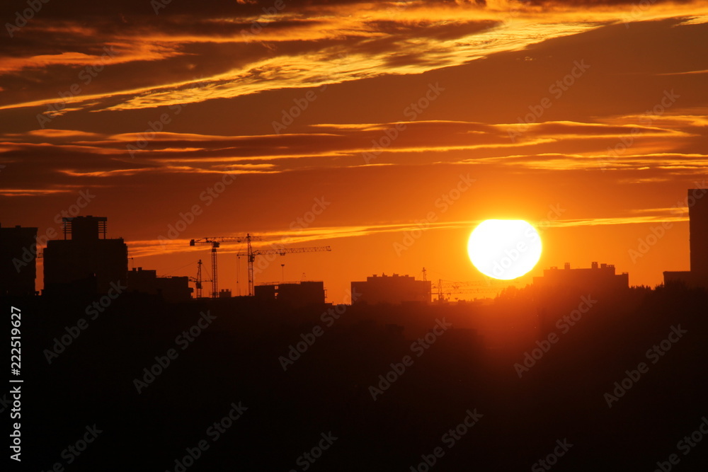 Cityscape with silhouette of city skyline against setting sun. Minsk, Belarus