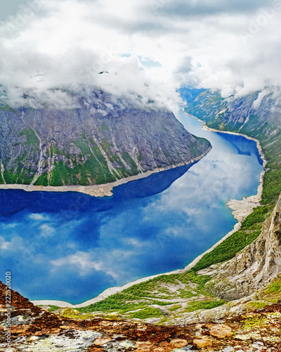 Untouched nature of Norway, Beautiful lake Ringedalsvatnet nearby famous landmark and travel destination - Trolltunga, the Tongue of Troll, Røldal, Norway. Pristine water-mountain landscape. photo