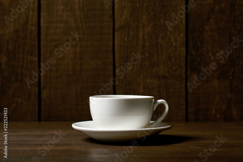 one classic coffee or tea cup on a dark wooden background