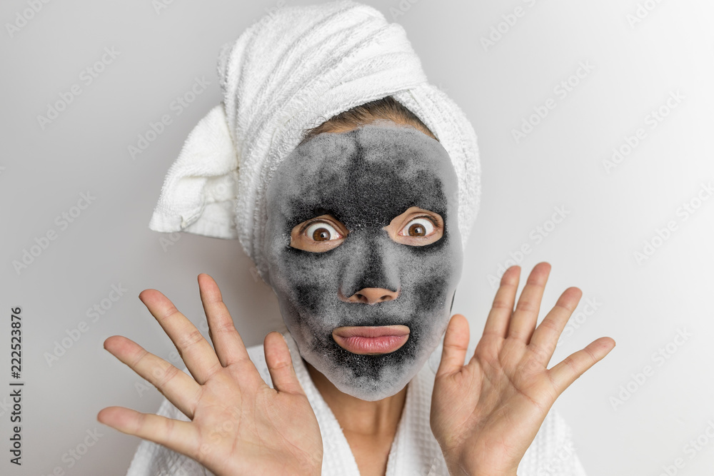 Face mask bubble foam funny woman at beauty spa looking or surprised, scary chemicals in beauty products. Asian girl wearing bath towel hair. Stock Photo | Adobe