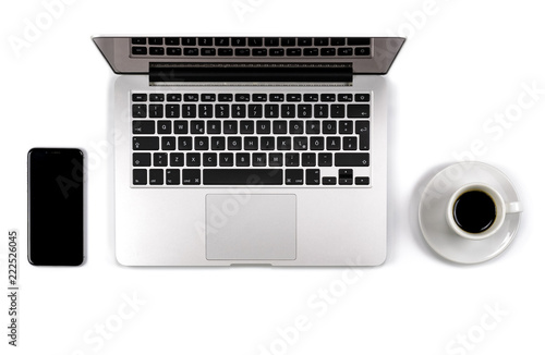 Top view of laptop with smartphone and cup of coffee