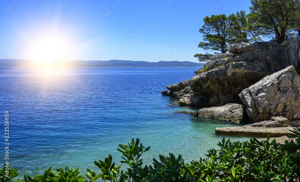 View of the beautiful beach and the blue sea on a sunny summer day. The Adriatic. View of the beautiful beach and the blue sea on a sunny summer day. The Adriatic.