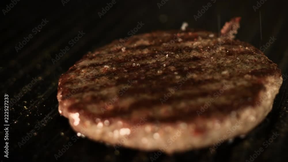 Burger on a Grill with Pepper and Salt Burger on a Grill with Pepper and Salt