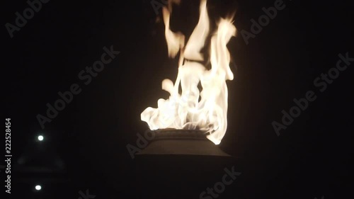 Closeup of flame of burning torch outdoors at night
