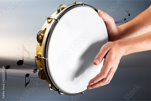 Carta da parati Female hands Playing the tambourine on background