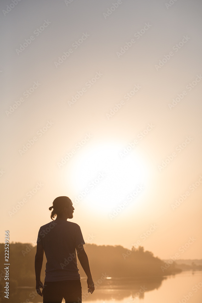 silhouette of man on background of sunset